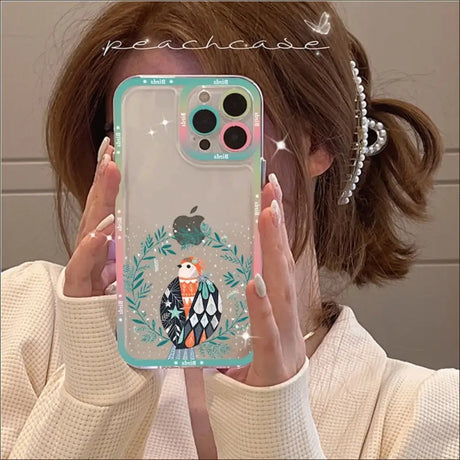 A woman holding up a phone case with a penguin on it