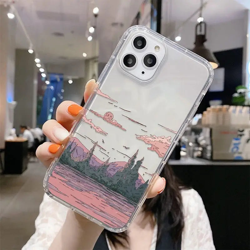 a woman holding up a phone case with a picture of a city