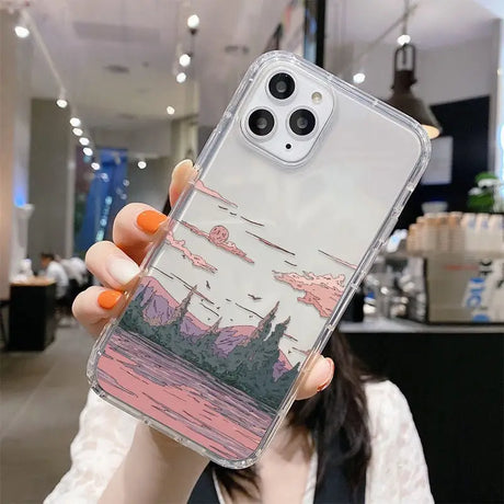 A woman holding up a phone case with a picture of a city