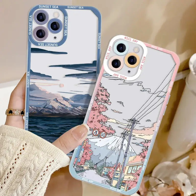 a woman holding a phone case with a picture of a mountain scene