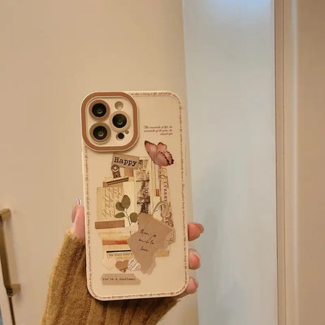 A woman holding a phone case with a picture of a house