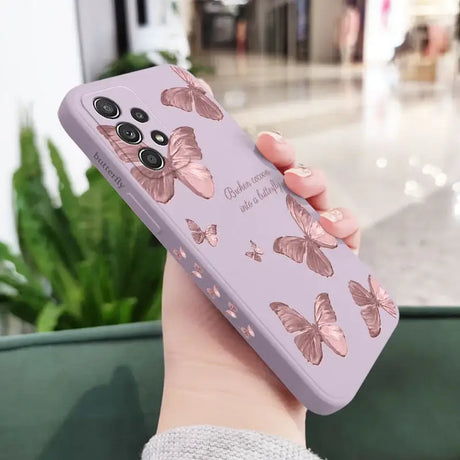 A woman holding a phone case with a pink butterfly pattern