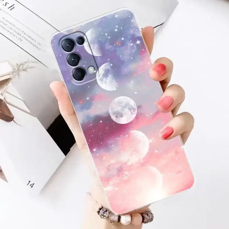 A woman holding a phone case with a pink and blue galaxy print