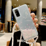 A woman holding a phone case with pink and white glitter