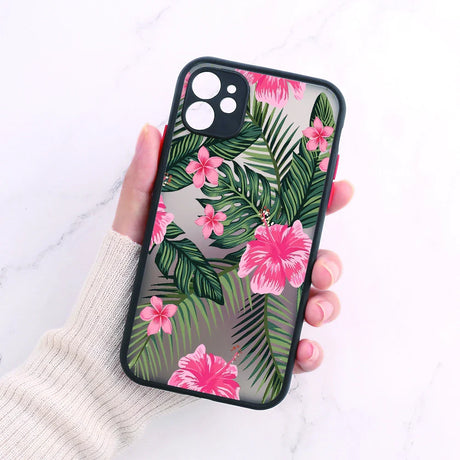 A woman holding a phone case with pink flowers