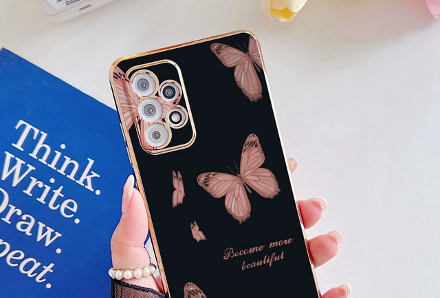 a woman holding a phone case with a pink butterfly pattern