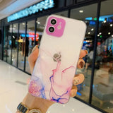 a woman holding up a phone case with a pink and blue marble design