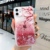 a woman holding a phone case with pink glitter