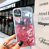 a woman holding a phone case with pink flowers on it