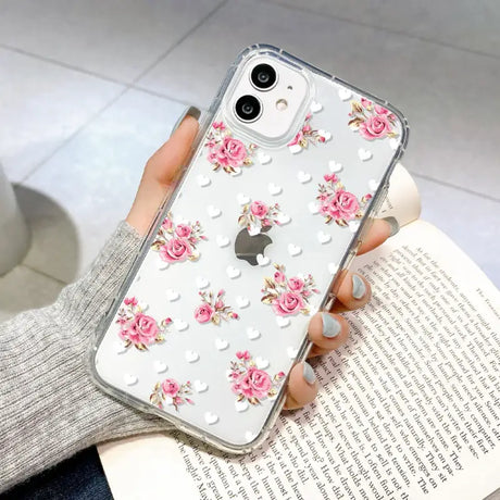 A woman holding a phone case with pink flowers on it