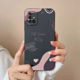 a woman holding a phone case with a pink and black design