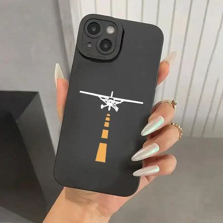 A woman holding a phone case with a plane on it