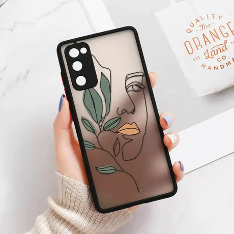 A woman holding a phone case with a plant on it