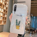 a woman holding a phone case with a plant in it
