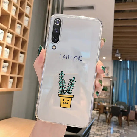 A woman holding a phone case with a plant in it