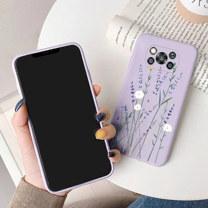 a woman holding a phone case with a purple flower design