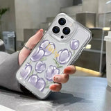 a woman holding a phone case with purple flowers on it