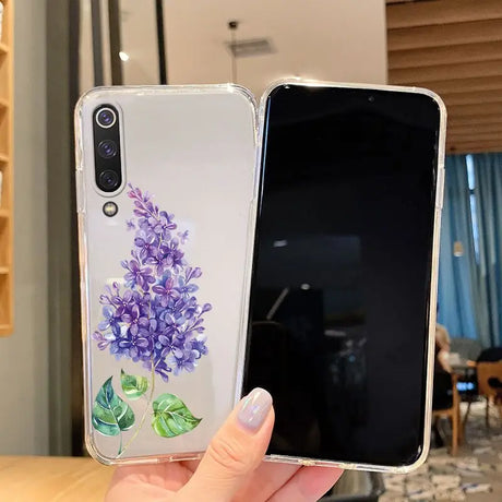 A woman holding a phone case with a purple flower on it