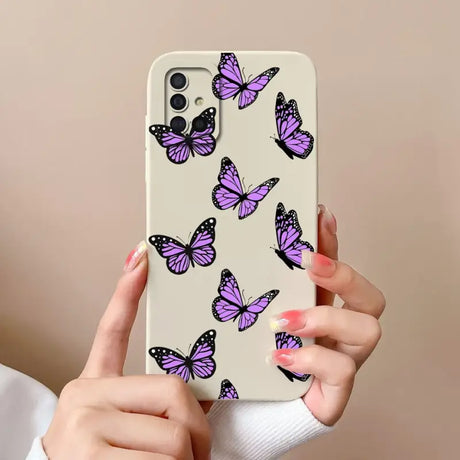a woman holding a phone case with purple butterflies on it