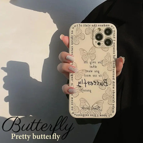 A woman holding a phone case with a quote on it