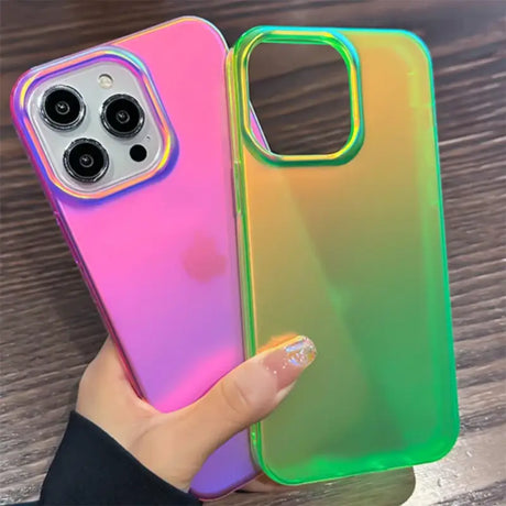 A woman holding a phone case with a rainbow colored case