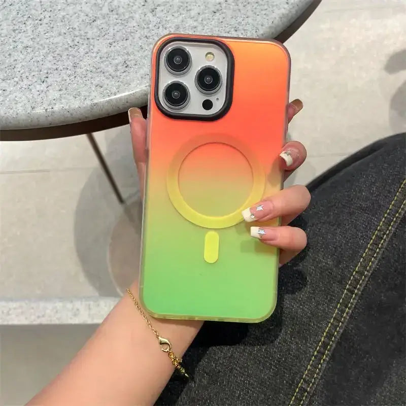 a woman holding a phone case with a rainbow colored phone cover
