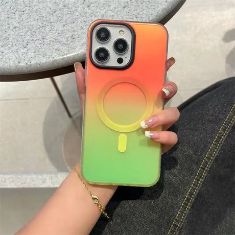 A woman holding a phone case with a rainbow colored phone cover