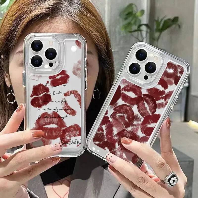 a woman holding up a phone case with red flowers on it