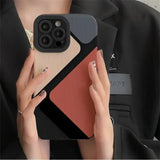 a woman holding a phone case with a red and black design