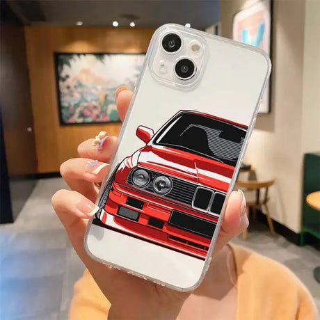 A woman holding a phone case with a red car