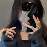 a woman holding up her phone case