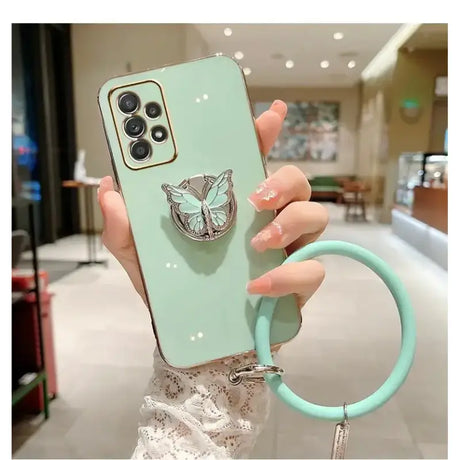 A woman holding a phone case with a ring