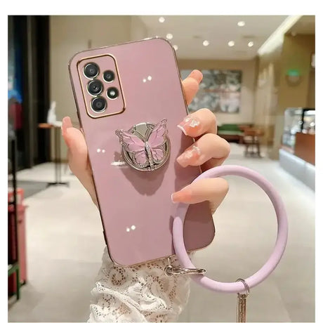 A woman holding a phone case with a ring