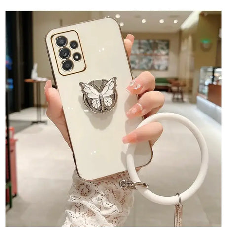 A woman holding a phone case with a ring