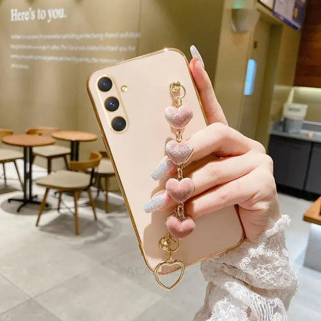 A woman holding a phone case with a ring on it