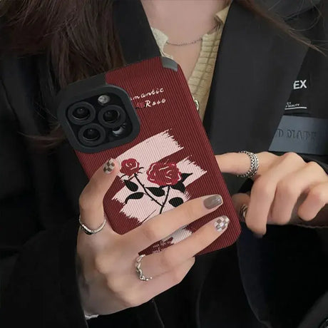 A woman holding a phone case with a rose on it