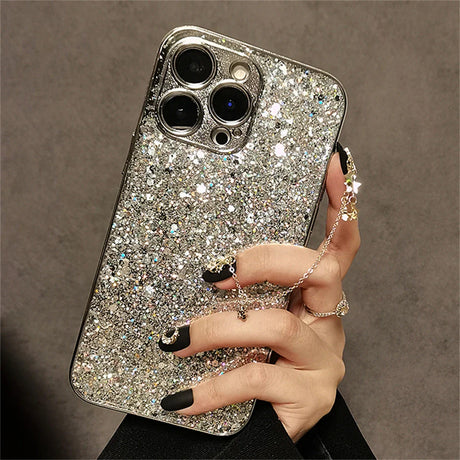 a woman holding a phone case with a silver glitter