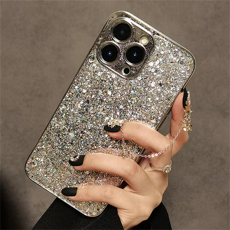 a woman holding a phone case with a silver glitter