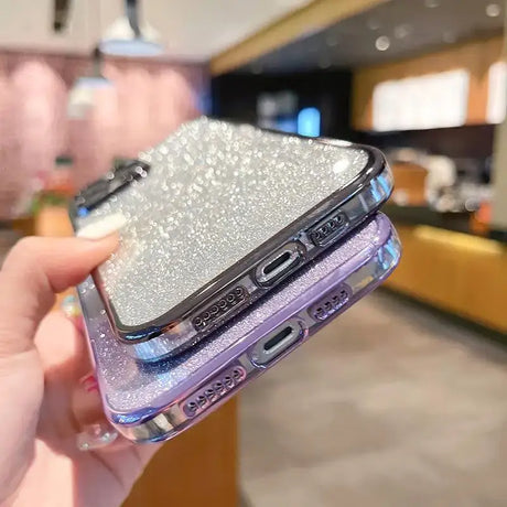 A woman holding a phone case with a silver glitter design