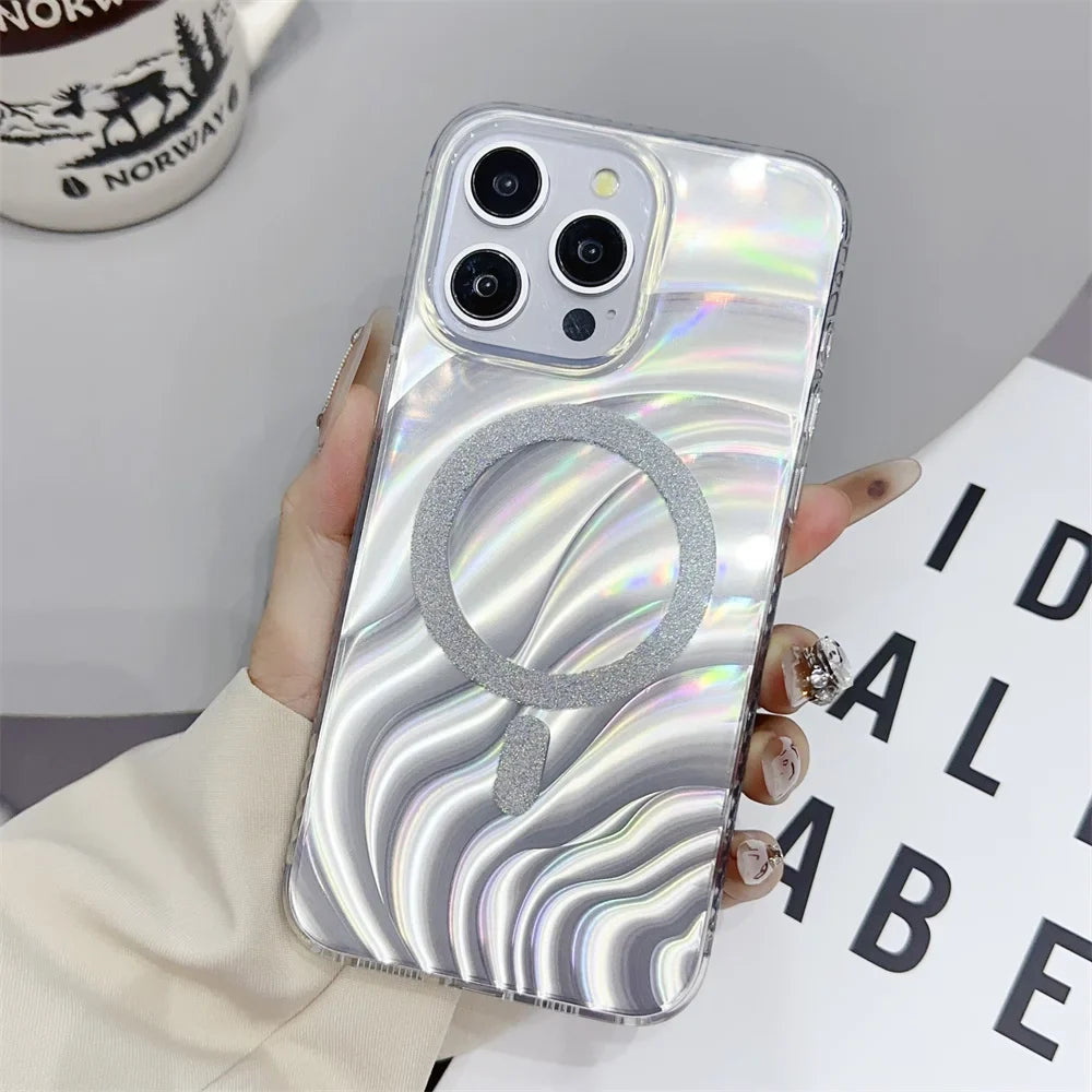 a woman holding a phone case with a silver swirl design