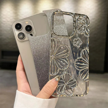 a woman holding a phone case with silver glitter