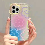 a woman holding a phone case with smiley faces on it