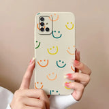 a woman holding a phone case with a smiley face pattern