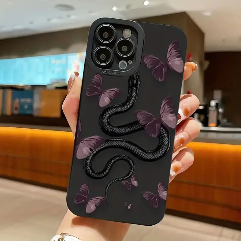 a woman holding a phone case with a snake on it