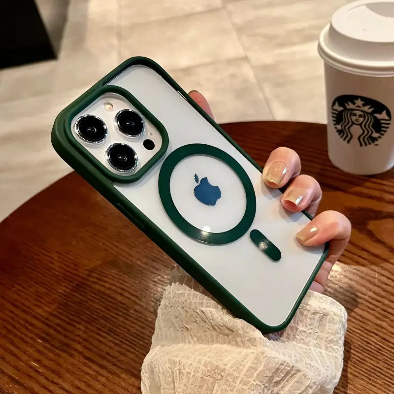 A woman holding a phone case with a starbucks cup in the background