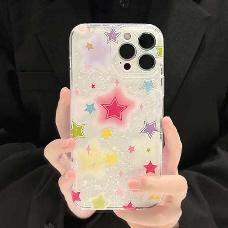 A woman holding a phone case with stars on it