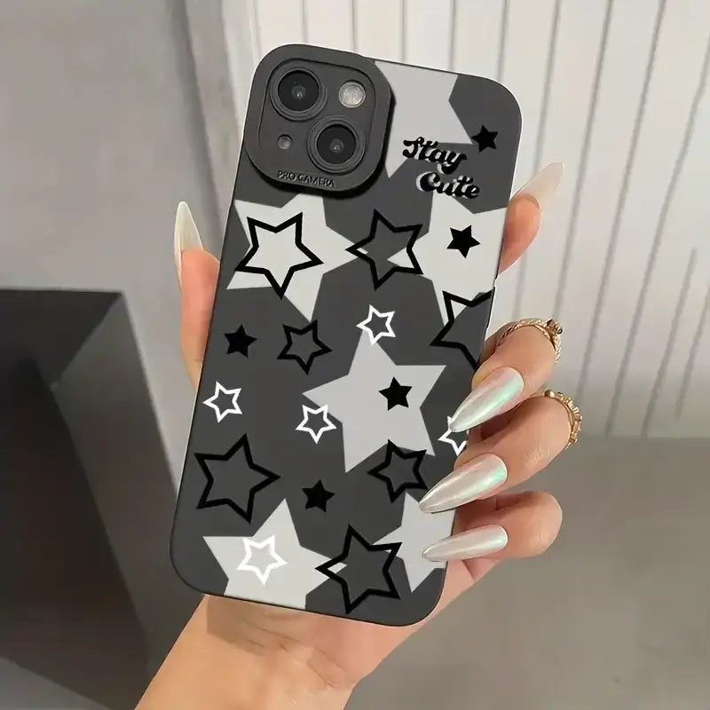 a woman holding a phone case with stars on it