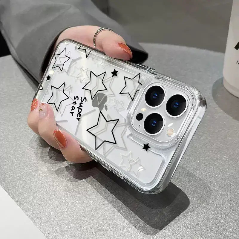 a woman holding a phone case with stars on it