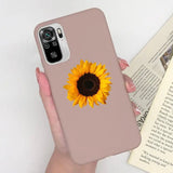 a woman holding a phone case with a sunflower on it
