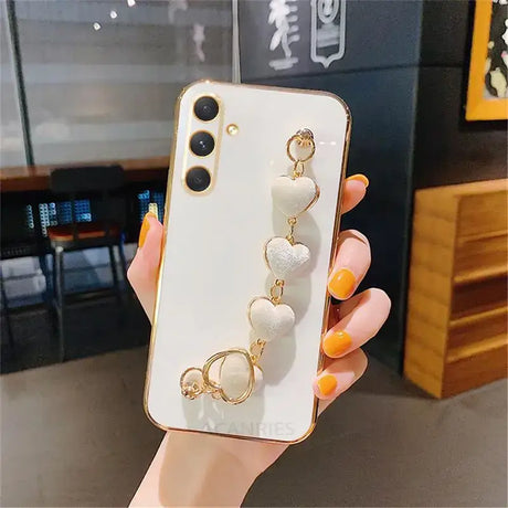 A woman holding a phone case with three rings